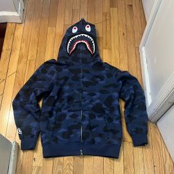 Selling a BAPE shark camo hoodie. It features a distinctive shark design on the hood and a tiger graphic on the back. The hoodie has a full zip closur