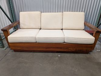 Mid-Century Style Wooden Sofa with Carved Leaf Arms and Cream Cushions