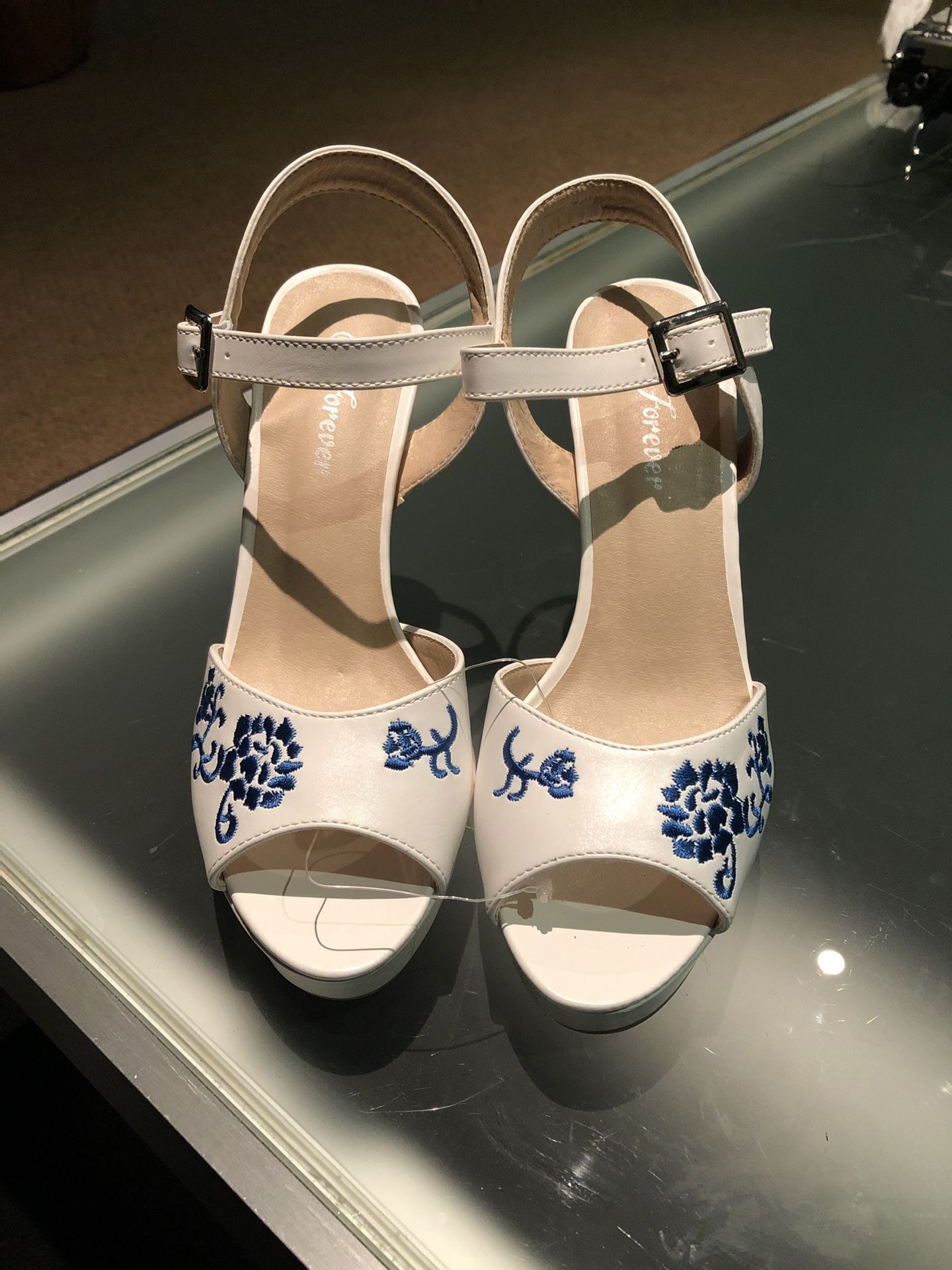 White high heels with blue embroidered flowers
