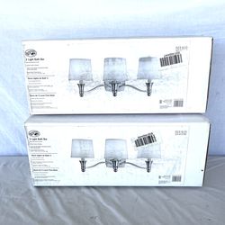 (2) brand new in the boxes (Hampton Bay) three light Bath bar light fixtures. Retails $100 each.