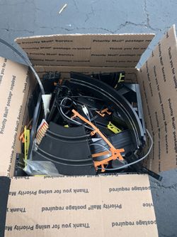 Box Filled With Slot Car Tracks and Accessories