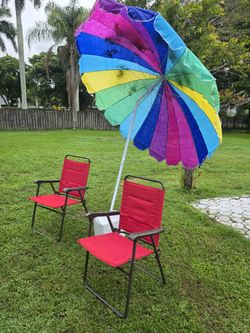 2 folding chairs plus an umbrella and a large styrofoam cooler
