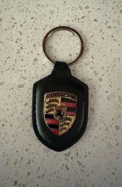 Porsche keychain Black leather With Enameled Shield. 2-1/2”