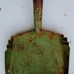Primitive Green Dust Pan Hangs On Wall