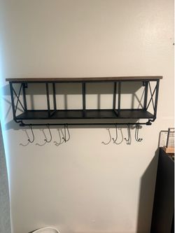 Two black distressed Metal shelves with wood top and hanging hooks