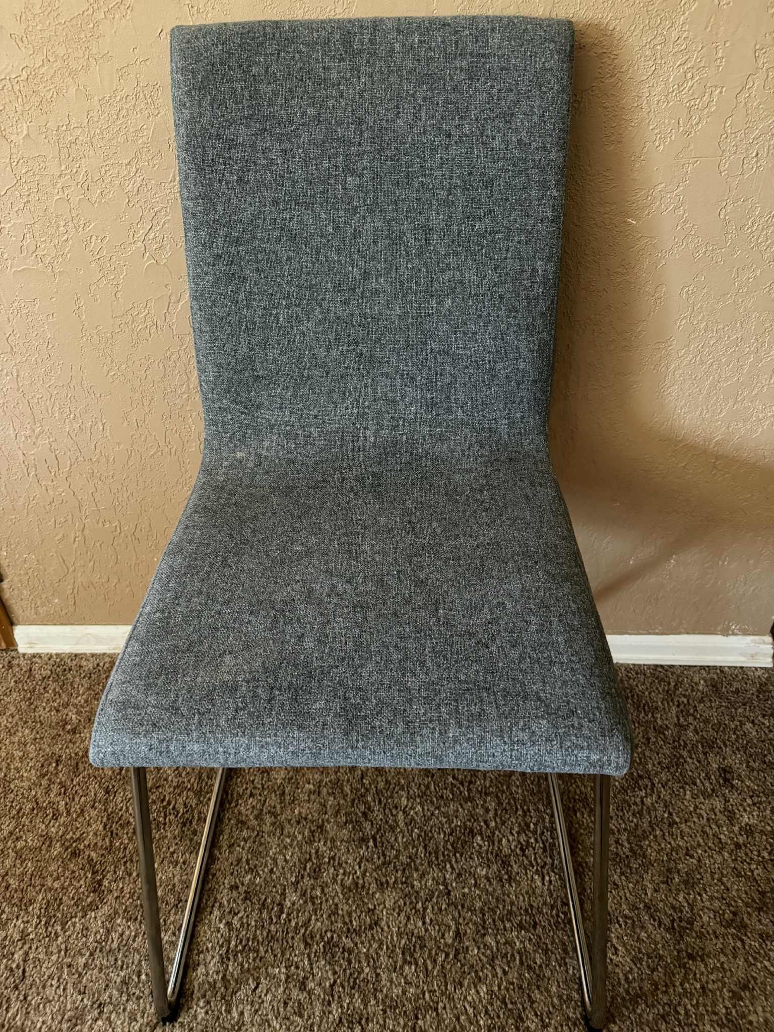 Modern gray upholstered chair with metal legs