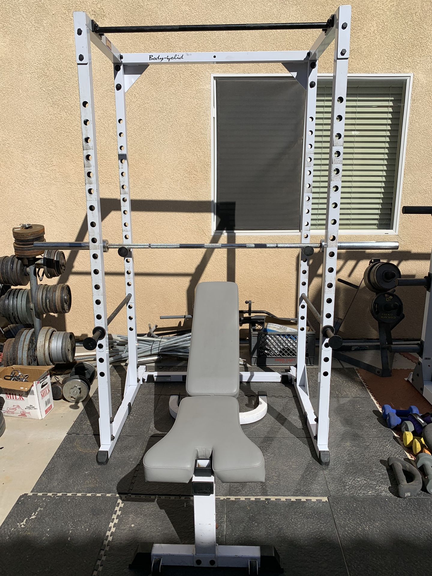 Body solid squat rack, weights plates, bar, bench and clips