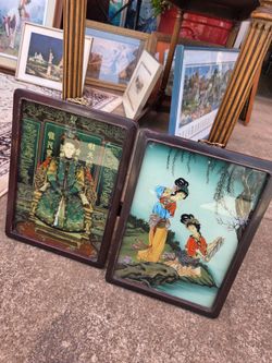 Traditional Chinese reverse-glass paintings framed in wood.