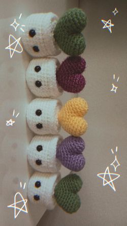 Handmade crochet ghost holding a heart.