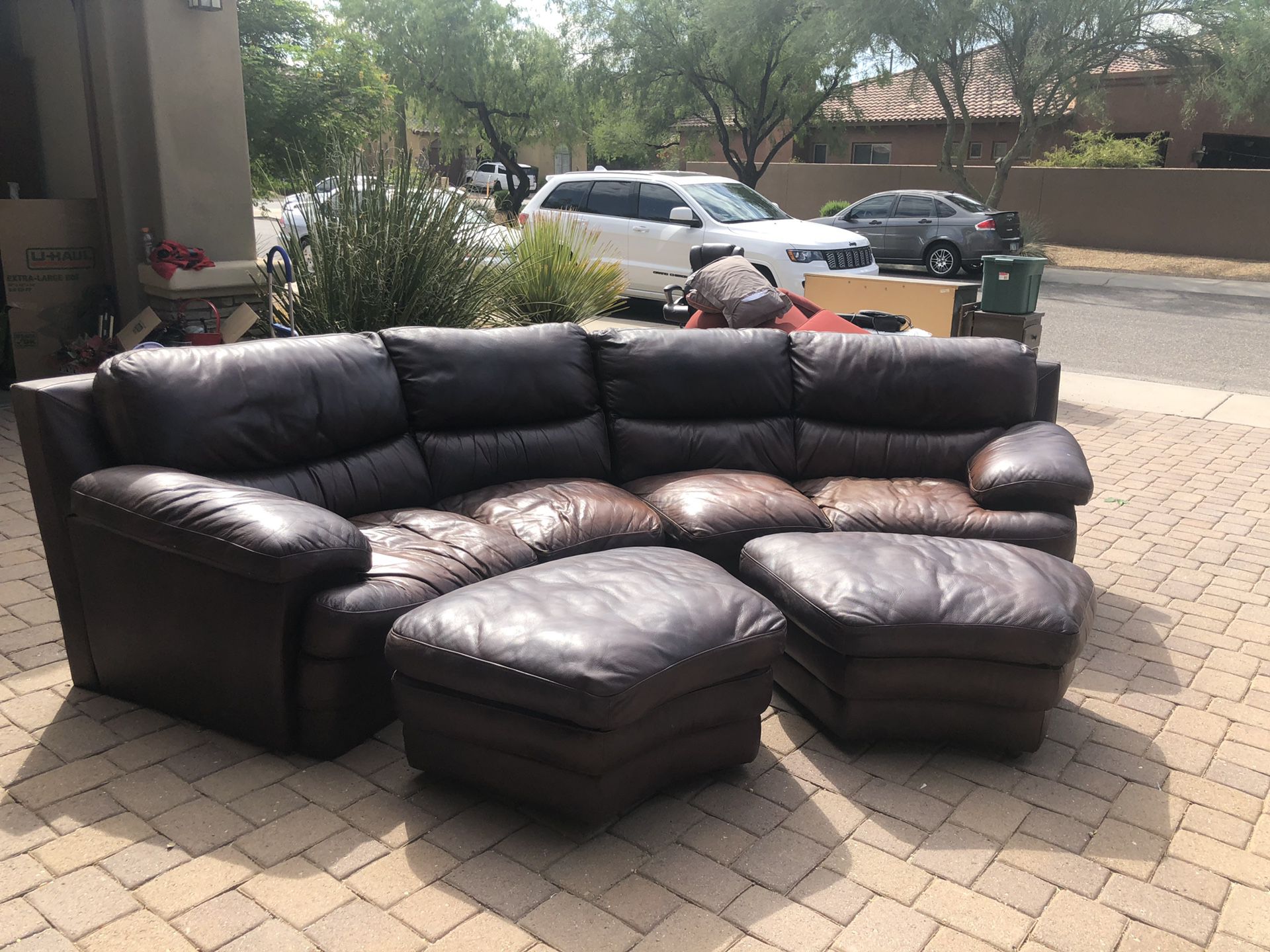 Brown Leather Couch with ottomans. Unique curved design. Original cost $2500.