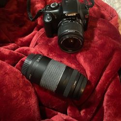 Canon EOS Rebel T3 (also known as the EOS 1100D) DSLR camera body with two interchangeable lenses