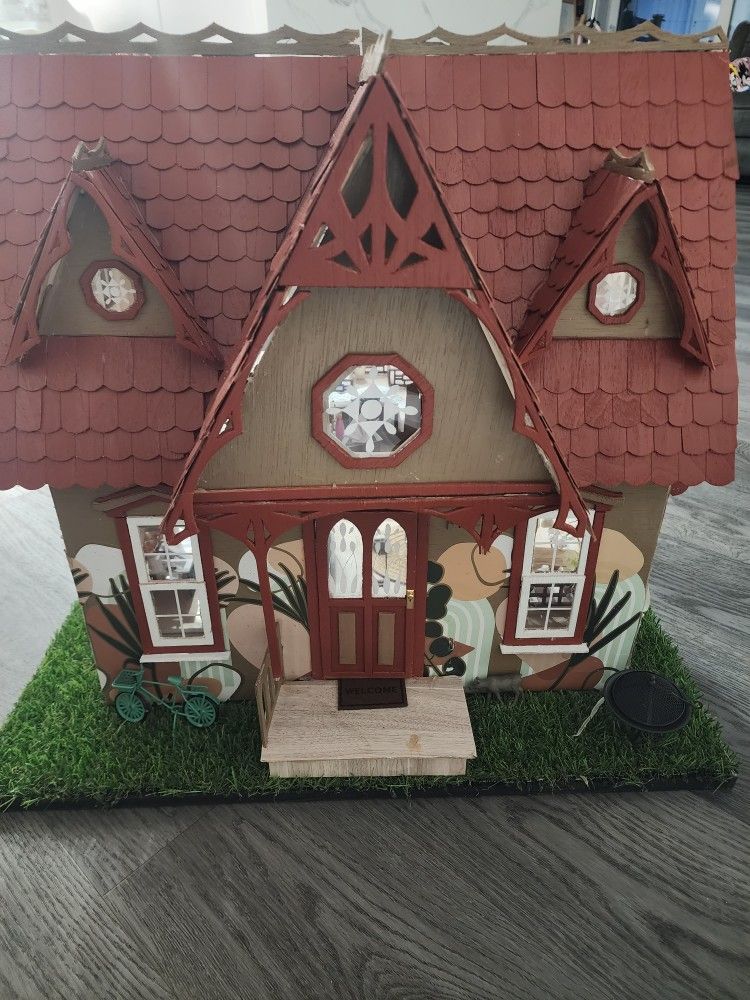 multi-story dollhouse featuring detailed furniture and decor