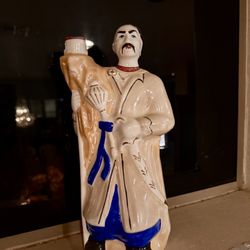 The figurine is a vintage Ukrainian Cossack porcelain bottle,