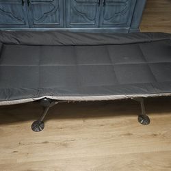 REI brand folding cot for camping