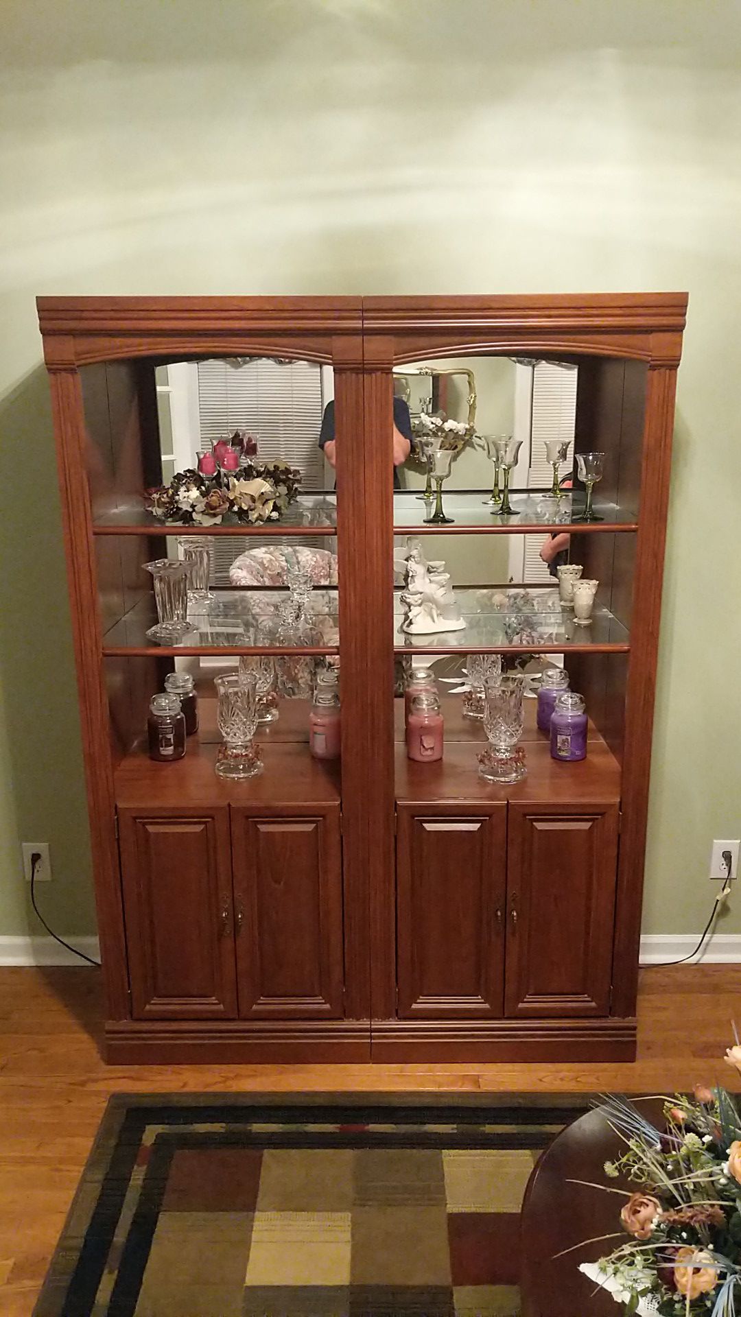 Two lighted cabinets with shelves