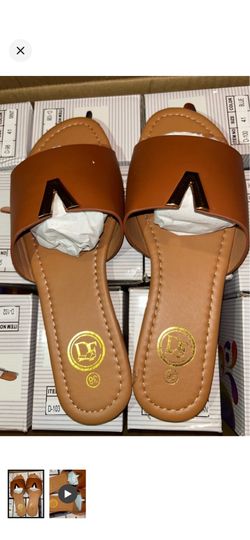 Stylish tan slide mules with a sleek gold V-