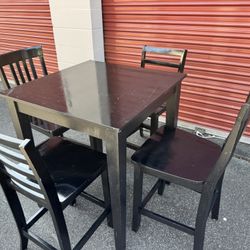 Wooden high table and four chairs