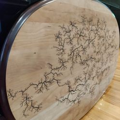 Lichtenberg Burns Fractal High Voltage 15KV Wood Art Cherry solid wood oval 46"x27.5"

Fractal Wood burning (Lichtenberg figures) using 15,000 volt ar