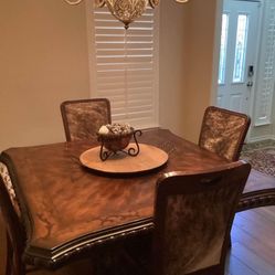 Maitland-Smith dining room table. Deer hide chairs 