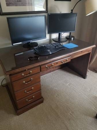 Office desk with storage for hanging files.