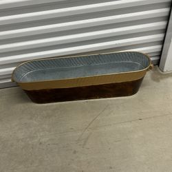 with a copper-finished exterior and rope handles