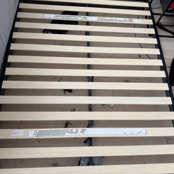 Queen platform bed frame — black steel, wood slats, no box spring needed