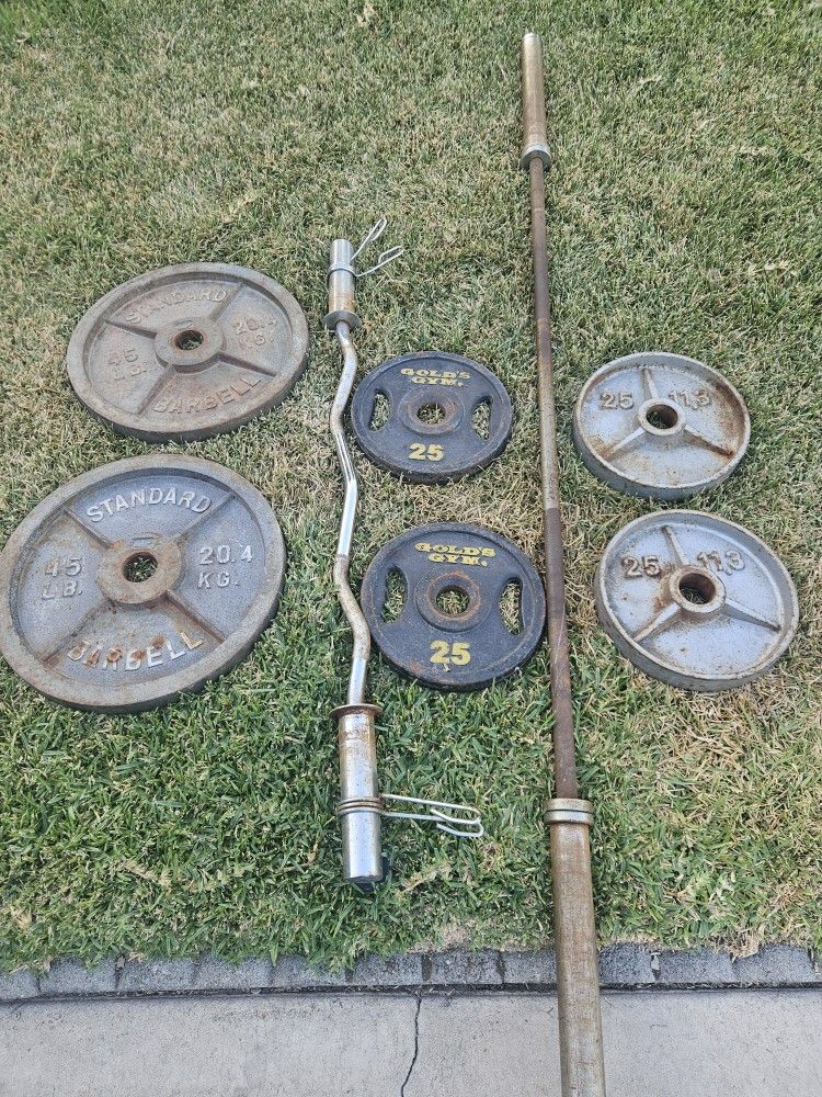 Cap 45lb 2 inch Olympic weight plates, 45lb straight bar, 4x25lb plates, curl bar with flat bench.