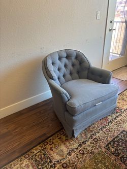 Ethan Allen cozy blue-gray upholstered armchair featuring classic button tufting and a subtle dotted pattern.