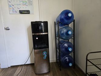 Primo Water Dispenser with water jugs and rack