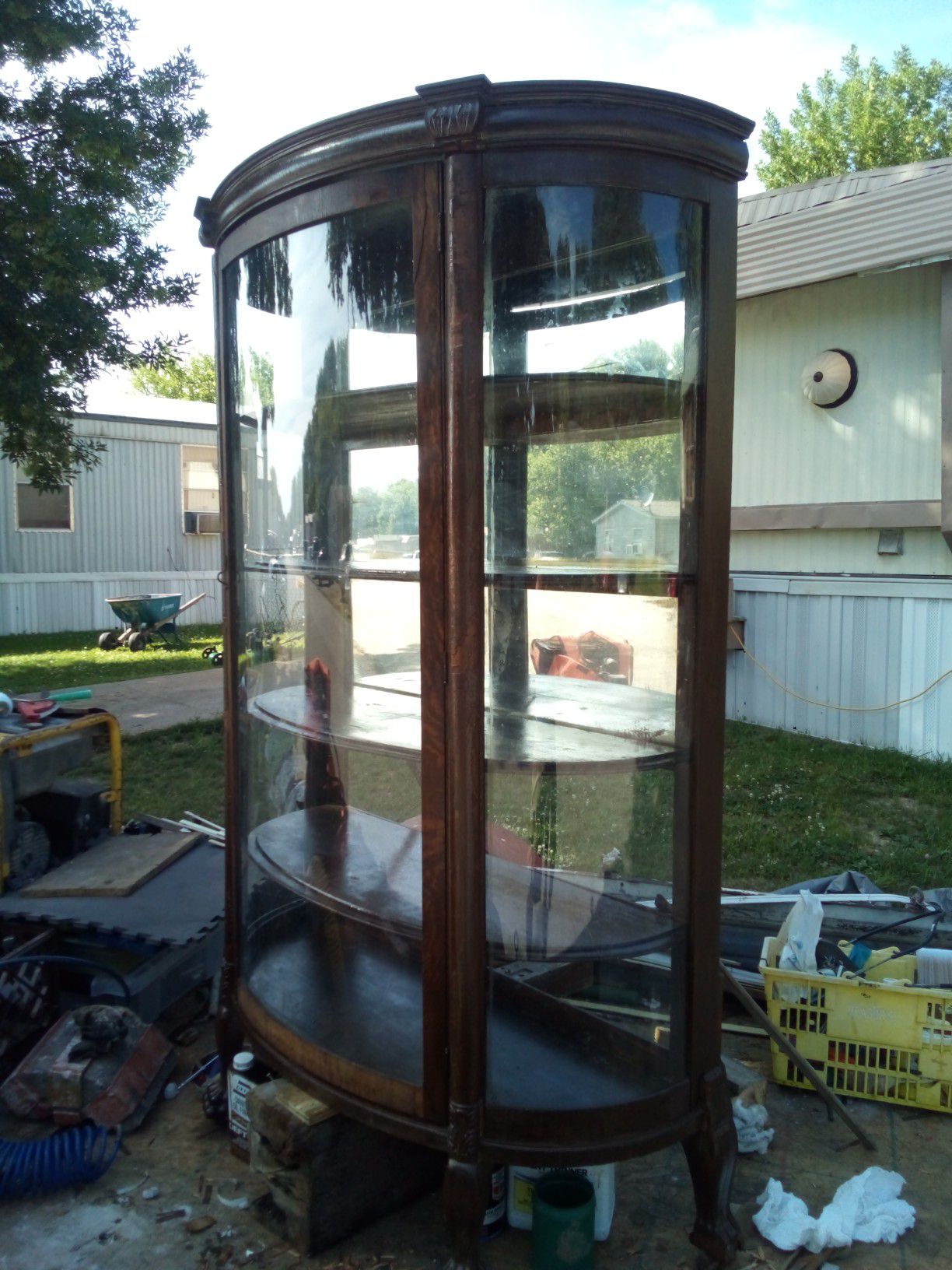 Antique curio cabinet with 4shelves and 3 curved glass sides.