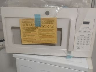 NEW GE OVEN THE RANGE MICROWAVE IN CREAM COLOR