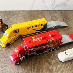 Disney/Pixar Cars hauler toy trucks. The yellow hauler belongs to Cruz Ramirez, and the red one is Mack, the transporter for Lightning McQueen