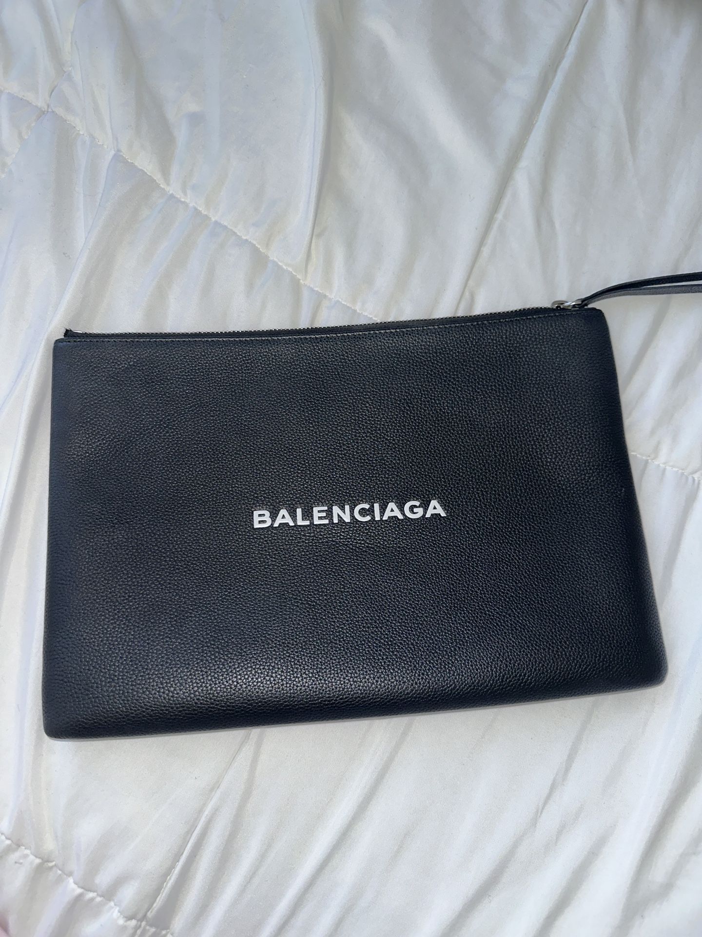 Balenciaga Pochette in black.
