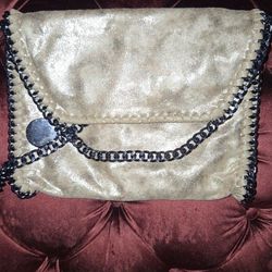 Gold purse with black chain strap