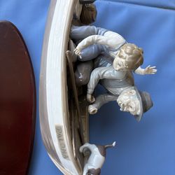 Lladro man and boy in boat with base