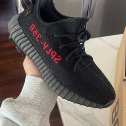 black Yeezy Boost 350 V2 with red “SPLY-350”).