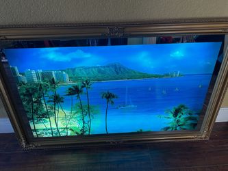 Picture frame vintage moving motion light and sound wall decor piece, often depicting a tropical or ocean scene. 