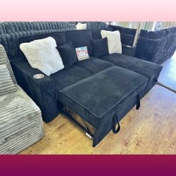 Black corduroy sectional sofa with pullout bed with cup holders 