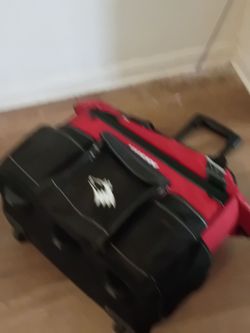Husky tool bag has wheels and a handle