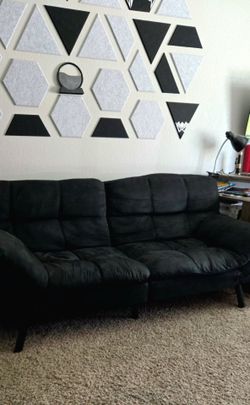 Black futon sofa bed. Reclines to bed.