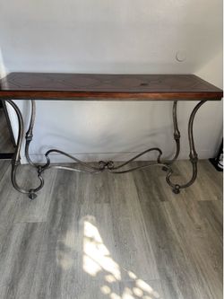 Solid wood table with iron Legs .