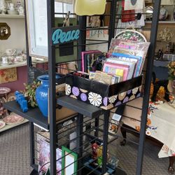 4 sided Black rotating metal shelf on wheels 