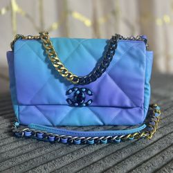 Blue And Purple Purse With A Leather Chain Strap