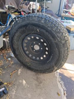 Goodyear Wrangler AT/S tire size P265/70R17 mounted on steel wheel