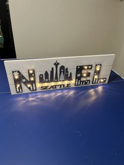 This is a decorative wooden Seattle landmark sign featuring the Space Needle and city skyline. 