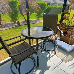 Outdoor Bristo table and two swivel chairs.