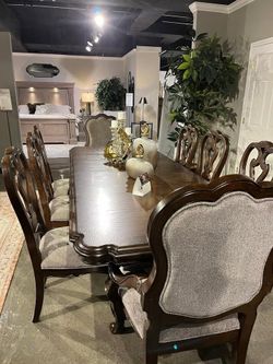 Brown finish dining set features large dining table w/2 extension leaf