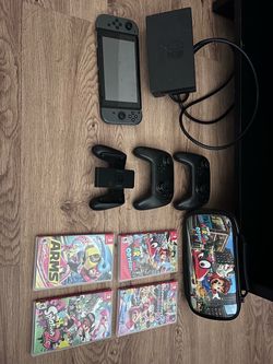 Nintendo Switch with case, controllers, and 4 games
