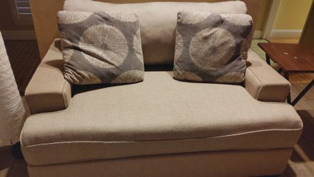 Loveseat and ottoman with pillows