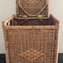  handwoven rattan or wicker laundry basket with a lid. 